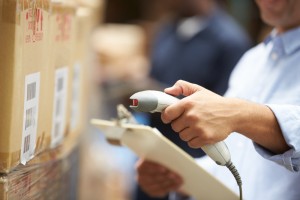 A person scanning a box in the warehouse